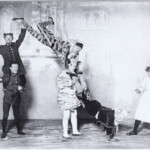 Pender Troupe appearing in the Harlequinade at the Theatre Royal, Drury Lane in the first decade of the 20th century. <br> Will Compo ( Power) is the sergeant, the nurse is Maggie Lomas. Bob Pender is the clown. <br>Photo courtesy of Rosie Jones and the Manders & Mitchinson Collection
Pender Troupe